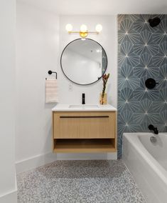 a bathroom with a sink, mirror and bathtub in it's center area