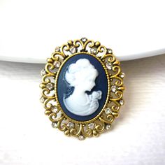 Gold Toned, Oval Filigree Cameo, Clear Rhinestones Brooch Pin 9517 Vintage blue back ground and white Cameo Female Previously owned and In very good Vintage condition. Please, contact us if you any questions. Beautiful pin! Please see my other listings for more vintage jewelry- I am happy to combine the shipping. Thanks so much!  Beautiful pin! Please see my other listings for more vintage jewelry- I am happy to combine the shipping. Thanks so much! Luxury Oval Filigree Brooches, Luxury Cameo Brooch, Back Ground, Blue Back, Thanks So Much, Rhinestone Brooches, Clear Rhinestones, Columbus, Brooch Pin