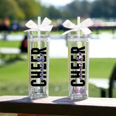 two clear tumblers with the words cheer on them