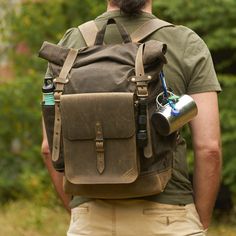 "Dark olive waxed canvas and olive leather backpack with PALS grid (often called MOLLE) on the front side. Bag made of 12oz (340 gr/cm) British waxed canvas and Italian full grain vegetable tanned leather (2mm thickness). Roll to close the top. Closes with two leather straps on buckles. The length of the strap allows you to fasten a raincoat or light jacket outside the backpack. Comfortable, padded shoulder straps made of waxed canvas and leather. Wide - 5 cm (2 in) PALS (or MOLLE) grid on backp Waxed Canvas Leather Backpack, Bushcraft Backpack, Hiking Day Pack, Safari Photo, Waxed Canvas Backpack, Canvas Rucksack, Personalized Gifts For Men, Leather Roll, Dopp Kit