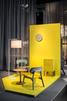 a yellow display with two chairs and a table