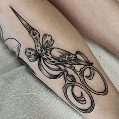 a tattoo on the leg of a woman with scissors in her hand and an octopus