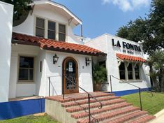 the front entrance to la fonda restaurant with red brick steps leading up to it