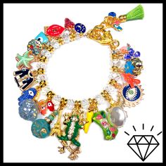 "LOADED gold charm bracelet just the way you like it with the addition of Crystals!! Tons of enamel charms with Czech crystals in between! Stunning! 7 3/4\" length with Lobster Clasp and adjustment chain. Actual charms may vary. All of my jewelry is handmade by me. No two are exactly alike. Hence the name, \"OKO by Andy\" (One-of-a-Kind). The photos in the listings are indicative of the style you will receive, not necessarily an exact representation since these are not mass made in a factory." Enamel Dangling Charms For Jewelry Making, Gold Enamel Bracelets With Charms, Gold Enamel Bracelet With Charms, Enamel Charms Bracelet, Gold Charm Bracelet As A Souvenir, Adjustable Charm Bracelet With Dangle Charms, Adjustable Charm Bracelet With Dangle Removable Charms, Adjustable Charm Bracelet With Removable Dangle Charms, White Dangle Charm Bracelet With Lobster Clasp