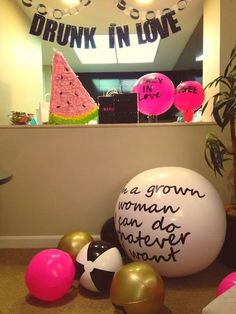 there are balloons and other decorations on the floor in front of a window that says drunk in love