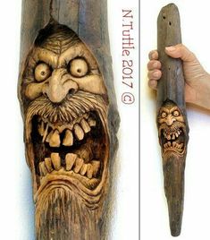 a wooden carving of an evil man holding a large knife