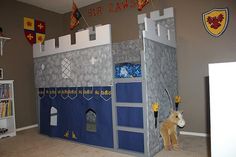 a child's bedroom with a castle bed and bookcase