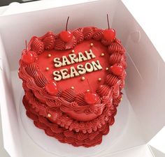 a heart shaped cake with the words sarah season written on it