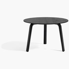 a round table with black legs on a white background