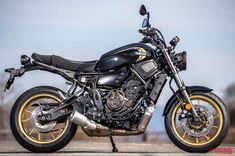 a black and gold motorcycle parked on the street