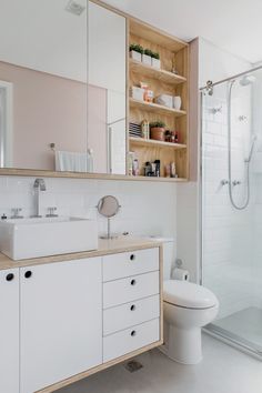 a bathroom with a sink, toilet and shower in it's own area is shown