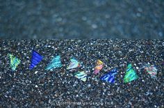 there are many different colored kites on the ground