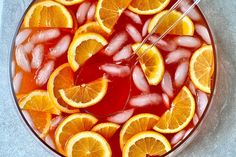 a bowl filled with orange slices and ice