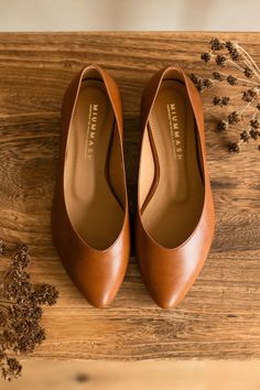 Our new, classic Mary Jane. Timeless, comfortable and ultra-feminine. Wonderfully comfortable thanks to the double softening of the insole. Stable, perfectly balanced heels. SIZE ADVICE: If you are hesitating between sizes, choose the smaller one. Ballerinas should fit snugly around the feet.   UPPER: full grain brown leather, cognac shade of brown INSIDE: vegetable-tanned cowhide leather, beige SOLE: brown (tuni leather)  HEEL: 1,5 cm  Our handmade shoes hold a 2-year guarantee; however, they last longer with proper care. Brown Mary Janes, Brown Leather Flats, Shade Of Brown, Ultra Feminine, Brown Flats, Shoe Inspo, Ballerina Shoes, Leather Mary Janes, Pointed Toe Flats