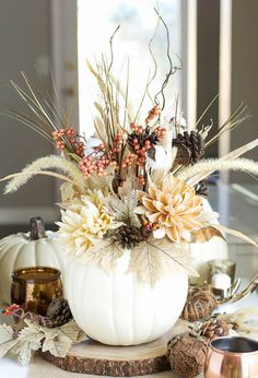 a white pumpkin filled with lots of flowers