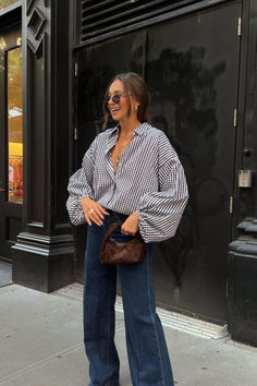 Model wearing our women's shirt which is a white and blue  classic check pattern. She is smiling and standing in front of a coffee shop. Warm Fall Day Outfit, Look Boho Chic, Latina Outfits, Skandinavian Fashion, Looks Street Style, Plaid Blouse, Outfit Inspo Fall