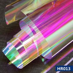 an iridescent colored object is sitting on a table with the words hrol3 above it