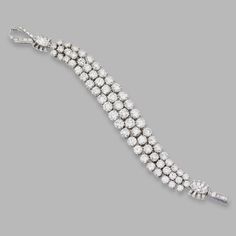 PLATINUM AND DIAMOND BRACELET, HARRY WINSTON, 1949. The highly flexible band set with round diamonds weighing 33.88 carats, accented by baguette and marquise-shaped diamonds weighing 3.49 carats, length 7 inches, numbered 4327, unsigned. Cartier Diamond Bracelet, Harry Winston Jewelry, Dancing Diamond, Bracelets Design, Harry Winston, Diamond Jewelry Designs