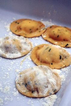 four small pastries are sitting on a baking sheet