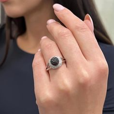 This Beautiful Diamond Cocktail Ring Is Crafted In Fine 14k White Gold. An Excellent Pave Set Of Black Round Brilliant Cut Diamonds Are Flanked As A Center Round Ball Surrounded With White Round Cut Diamonds. Total Diamond Weight: 1.25 Carats. Diamond Color I And Si Clarity. Ring Size: 7.5. Total Weight: 4.21 Grams. Comes In Our Presentable Jewelry Box. Id: 02967 Black Diamond Ring With Halo Setting For Anniversary, Black Diamond Ring With Pave Setting, Black Round Cut Jewelry With Pave Setting, Black Diamond Ring With Vvs Clarity And Round Shape, Black Round Diamond Ring With Vvs Clarity, Black Diamond Platinum Ring For Anniversary, Black Diamond Jewelry With Pave Setting, Black Pave Setting Jewelry For Wedding, Black Platinum Ring With Brilliant Cut