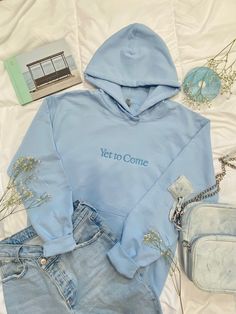 "A plush comfortable light blue embroidered hoodie celebrating the album of South Korean group BTS. Front pocket with fresh and simple \"Yet to Come\" embroidered design. This hoodie gives a subtle design for everyday wear, showing off your love for Bangtan and looking stylish. ~Sweatshirt is 50% cotton, 50% Polyester ~Made to be pill-resistant ~Made with 50% sustainability-grown cotton. ~Double needle stitching throughout. ~1x1 ribbed collar, cuffs, and waistband with spandex WANT BIGGER THAN 3X? Message for special order." Trendy Embroidered Hooded Hoodie, Cotton Kpop Hoodie, Light Blue Cotton Hoodie For Winter, Winter Cotton Hoodie In Light Blue, Light Blue Hoodie Sweatshirt For Spring, Trendy Light Blue Cotton Hoodie, Blue Embroidered Cotton Hoodie, Casual Spring Hoodie With Letter Embroidery, Spring Casual Hoodie With Letter Embroidery