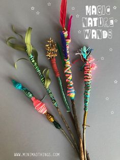 three colorful sticks with feathers on them and the words magic wands