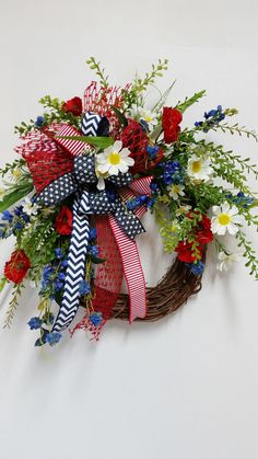 a wreath with red, white and blue flowers