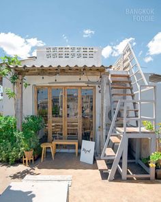 an outdoor patio with stairs and potted plants