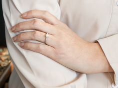 a close up of a person wearing a wedding ring