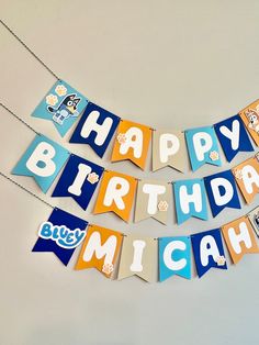 a birthday banner that says happy birthday mich and has cartoon characters hanging from it