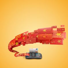 an old cell phone is wrapped in red and gold paper with chinese writing on it