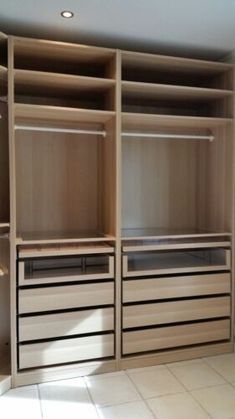 an empty walk in closet with lots of drawers