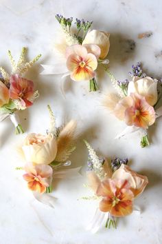 six flowers are arranged on a marble surface