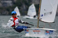 a man riding on the back of a sail boat