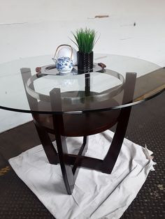 a glass table with a vase on it