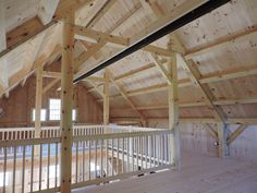 an empty loft with wooden walls and beams