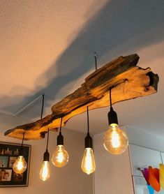 some light bulbs are hanging from a wooden beam