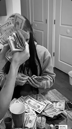 a woman sitting on the floor with money in her hands