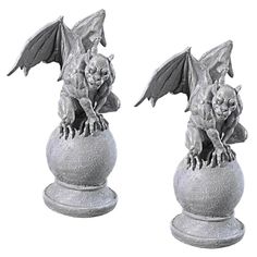 two statues of bats sitting on top of each other