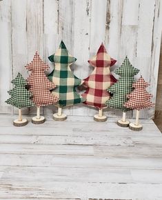 three small wooden christmas trees sitting next to each other