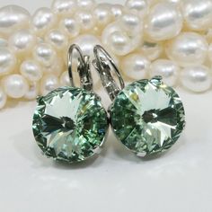 "Green Crystal Earrings Mint Drop Earrings Light Pale Green Chrysolite 14mm Swarovski Bridesmaids Gift Green wedding,Gold,Chrysolite,GE106 A sparkly pair of Drop Earrings made with genuine 14mm SWAROVSKI CRYSTALIZED™ ELEMENTS. Total diameter of the stone and strass 9/16\" (14mm) Total Length of earring 1\" (25mm) Will add just the right hint of color. Check the additional photos to choose more colors. There are matching necklaces rings and bracelets to go with it in my shop. All items are sent i Green Faceted Round Earrings, Green Round Faceted Earrings, Green Faceted Earrings For Anniversary, Green Faceted Earrings For Wedding, Hypoallergenic Green Jewelry For Weddings, Green Round Crystal Earrings For Formal Occasions, Green Crystal Wedding Earrings With Ear Wire, Green Round Clip-on Earrings For Anniversary, Green Round Crystal Earrings For Wedding