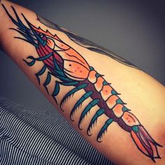 a man's arm with a colorful scorpion tattoo on it