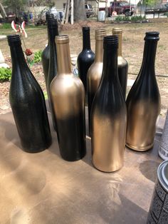 several black and gold vases sitting on top of a table