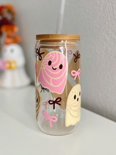 a glass jar with some stickers on it