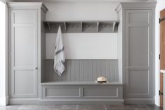 an empty bench with a hat and towel on it in the corner of a room