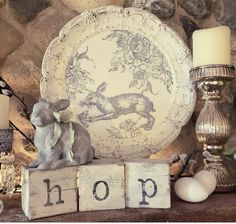 a table topped with plates and candles on top of a wooden block that says hop