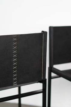 two black chairs sitting next to each other