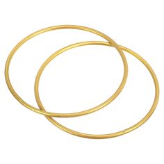 two gold colored metal rings on a white background