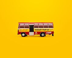 a red and yellow bus is sitting on a yellow background with the words india written in english