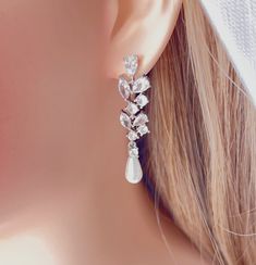 a close up of a pair of earrings on a mannequin headdress